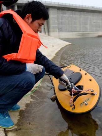 A water protection official monitors quality levels at the source of the central route of the South-to-North Water Diversion Project in Nanyang, Henan province, on March 4. (Photo/Xinhua)  