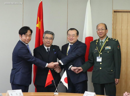 Liu Jianchao (2nd R), China's assistant foreign minister, shakes hands with Japanese Deputy Foreign Minister Shinsuke Sugiyama (2nd L) during a meeting in Tokyo, Japan, March 19, 2015. Foreign and defense officials from China and Japan kicked off a high-level security meeting here on Thursday, the first one between the two sides in more than four years. (Xinhua/Liu Tian)