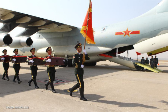 Soldiers of the Chinese People's Liberation Army carry coffins containing remains of soldiers of the Chinese People's Volunteers (CPV) dead in the 1950-53 Korean War, during a handover ceremony at the Inchon International Airport of South Korea, March 20, 2015. (Xinhua/Yao Qilin) 