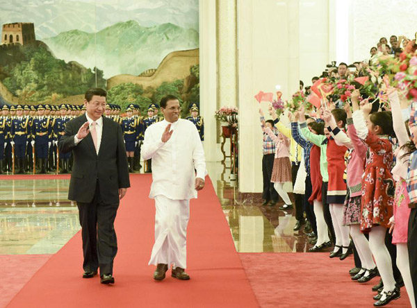 Chinese President Xi Jinping (L) holds a welcoming ceremony for Sri Lankan President Maithripala Sirisena before their talks in Beijing, capital of China, March 26, 2015. (Photo/Xinhua)
