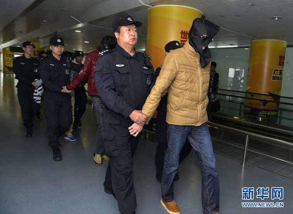 An economic criminal who fled to Thailand is sent back to southern city of Guangzhou in China on Dec. 16, 2014. (Photo/Xinhua)
