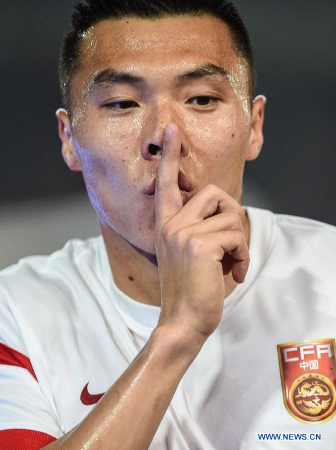 China's Yu Dabao celebrates after scoring during a soccer friendly match against Tunisia in Nanjing, capital of east China's Jiangsu Province, March 31, 2015. The match ended in a 1-1 draw. (Xinhua/Yang Lei) 