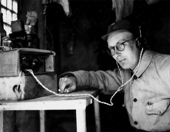 Michael Lindsay tunes a radio receiver at the Jinchaji base in Hebei province sometime between 1941 and 1944. Provided to China Daily  