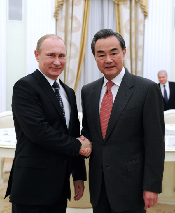 Russian President Vladimir Putin meets with Chinese Foreign Minister Wang Yi in Moscow on Tuesday. (DAI TIANFANG / XINHUA)