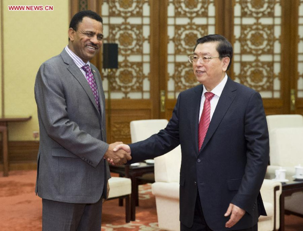 Zhang Dejiang (R), chairman of the Standing Committee of China's National People's Congress, shakes hands with Ethiopian Speaker of the House of Federation Kassa Teklebirhan in Beijing, capital of China, April 8, 2015. (Xinhua/Huang Jingwen)