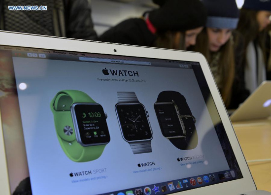 Customers test Apple products at Apple flag store in Manhattan, New York, the United States, on April 9, 2015. Apple Watch, the first Apple product to be worn, will be available for purchase online on April 24, and customers can pre-order from April 10. (Xinhua/Wang Lei)