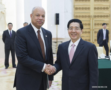 Chinese State Councilor and Public Security Minister Guo Shengkun (R) shakes hands with US Secretary of Homeland Security Jeh Johnson during the first ministerial meeting between the Chinese Ministry of Public Security and the US Homeland Security Department in Beijing, China, April 9, 2015. (Photo/Xinhua)