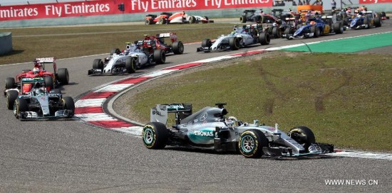 Mercedes AMG driver Lewis Hamilton (bottom) of Britain drives during the Chinese Formula One Grand Prix at Shanghai International Circuit in Shanghai, China, April 12, 2015. Hamilton won the race in 1 hour 39 minutes 42.008 seconds. (Xinhua/Fan Jun)
