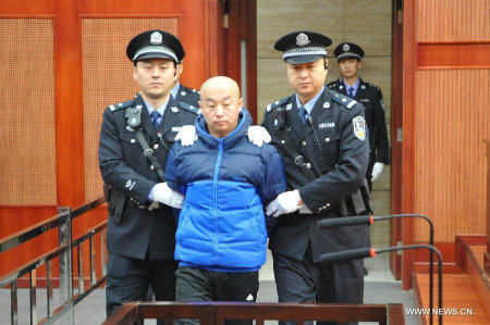 Alleged serial killer Zhao Zhihong is escorted to stand trial for murder, rape, robbery and larceny at the Hohhot Intermediate People's Court in Hohhot, capital of north China's Inner Mongolia Autonomous Region, Feb. 9, 2015.(Xinhua)