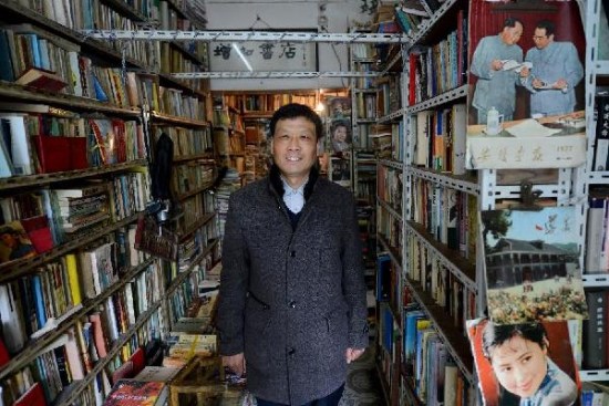 Zhu poses for photo in his bookstore on April 21, 2013. (Photo/Xinhua)