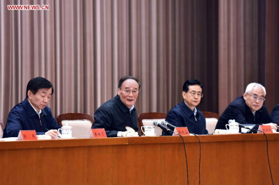 Wang Qishan (2nd L), a member of the Standing Committee of the Political Bureau of the Communist Party of China (CPC) Central Committee and secretary of the CPC Central Commission for Discipline Inspection (CCDI), addresses the launching of training classes on the establishment of CCDI branches, in Beijing, capital of China, April 19, 2015. Wang also gave a speech on studying President Xi Jinping's speeches at the launching on Sunday. (Xinhua/Li Tao)