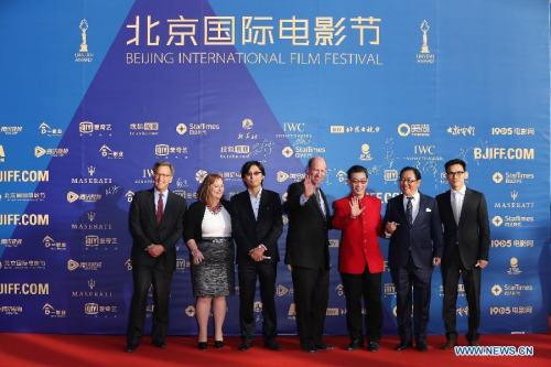 Chinese actor Zhang Jinlai (stage named Liuxiao Lingtong, 3rd R), Ma Dehua (2nd R) and other crew members of the movie Journey To the West walk the red carpet during the opening ceremony of the fifth Beijing International Film Festival (BJIFF) in Beijing, capital of China, April 16, 2015. The BJIFF kicks off Thursday and will last until April 23. (Photo: Xinhua/Xing Guangli)