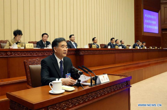 Chinese Vice Premier Wang Yang (front) delivers a report on pilot free trade zone during the second plenary session of the 14th meeting of the 12th National People's Congress (NPC) Standing Committee in Beijing, China, April 22, 2015. Zhang Dejiang, chairman of the NPC Standing Committee, attended the meeting. (Xinhua/Liu Weibing)
