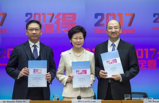 Carrie Lam Cheng Yuet-ngor (C), chief secretary for administration of Hong Kong Special Administrative Region (HKSAR), Secretary for Justice Rimsky Yuen (L), Secretary for Constitutional and Mainland Affairs Raymond Tam, shows the Consultation Report and Proposals on Method for Selecting the Chief Executive by Universal Suffrage in Hong Kong, south China, April 22, 2015.(Xinhua/He Jingjia) 