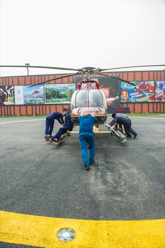 Staff from Beijing Reignwood Star General Aviation Corporation ready a helicopter for flight. (Photo: GT/Li Hao)