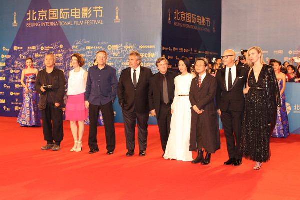 Jury president of the Tiantan awards Luc Besson (centre) is joined by jury members (from left) Kim Ki-duk, Fernando Meirelles and his wife, Robert Mark Kamen, Zhou Xun, Peter Chan and Fyodor Bondarchuk at the closing ceremony of the 5th Beijing International Film Festival on April 23, 2015. (Photo: CRIENGLISH.com/chloelyme)