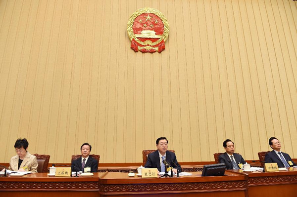 Zhang Dejiang (3rd L), chairman of the Standing Committee of China's National People's Congress (NPC), presides over the 14th meeting of the 12th NPC Standing Committee, in Beijing, China, April 24, 2015. China's top legislature ended its bimonthly session on Friday, with revised laws on food safety and advertising, and giving the go-ahead to changes to the jury system. (Photo: Xinhua/Rao Aimin)