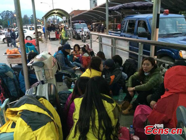 Chinese tourists are seen outside the Kathmandu airport after an 8.1-magnitude earthquake hits Nepal on Saturday, April 25, 2015. The airport was shut on Saturday following the strong earthquake. (Photo/China News Service)