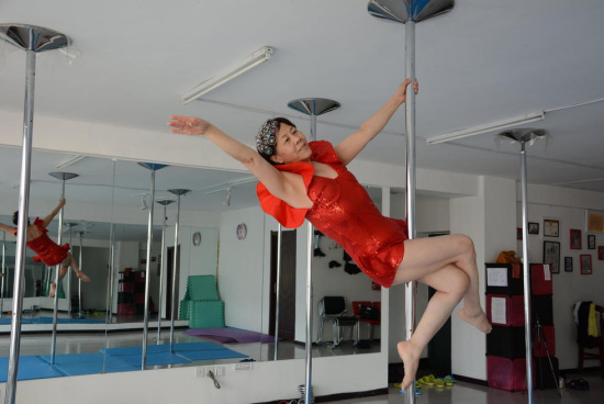 65-year-old Chinese woman Jiang Zhijun practices pole dancing in Jilin province, northeast China on April 24, 2015.(Photo/youth.cn) 