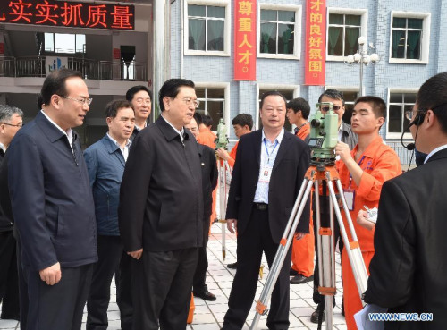 Zhang Dejiang (front, 2nd L), chairman of the Standing Committee of China's National People's Congress (NPC) and a member of the Standing Committee of the Political Bureau of the Communist Party of China (CPC) Central Committee, visits Chongqing industrial and commercial school in Chongqing, southwest China, April 26, 2015. Zhang Dejiang, leading an inspection team, reviewed the implementation of the Vocational Education Law in Chongqing from April 25 to 27. (Xinhua/Gao Jie)