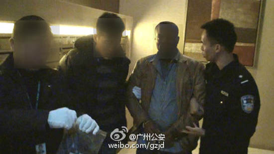 A suspected member of the 'Freedom Fighters', second from right, is arrested. (Photo/Weibo)