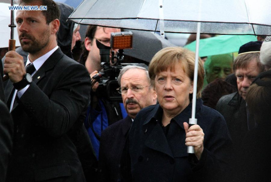 German Chancellor Angela Merkel (R, front) attends a ceremony in the Dachau Concentration Camp in Dachau, Germany, on May 3, 2015. German Chancellor Angela Merkel on Sunday delivered a speech marking the 70th anniversary of the liberation of the Dachau Concentration Camp, becoming the first incumbent chancellor to speak here. (Xinhua/Song Guocheng)