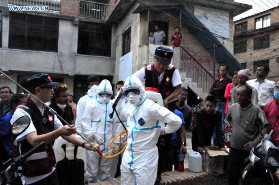 Members of China Medical Team instruct local people in disinfecting skills in Kirtipur in Nepal, on May 2, 2015. As a responsible global power and Nepal's neighbor, China responded immediately to Nepal's call after the magnitude-7.9 quake hit Nepal, leaving more than 6,600 people dead and many more still missing. (Xinhua/Zhao Yishen)