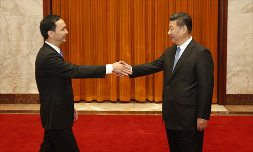Xi Jinping (right), general secretary of the Central Committee of the Communist Party of China, meets with Kuomintang Chairman Eric Chu Li-luan in Beijing on Monday. (Photo/China News Service)
