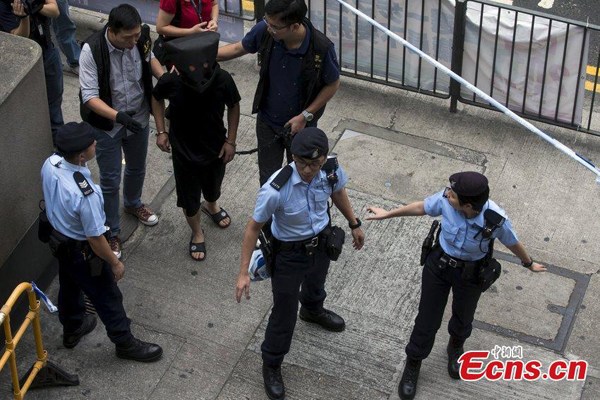 An alleged kidnapper of Hong Kong heiress Queenie Law, the granddaughter of Bossini founder Law Ting Pong, is escorted by police in Hong Kong, May 5, 2015. Police nabbed five remaining suspects who fled from Hong Kong with millions in ransom money after a kidnap, a day after the arrest of another suspect in the case. (Photo/CFP)