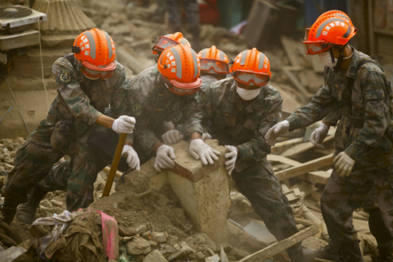 Chinese rescuers work on debris in Sankhu on the outskirts of Kathmandu, Nepal, April 30, 2015. Members of rescue teams from China and Nepal made joint effort to find victims. (Photo/Xinhua)
