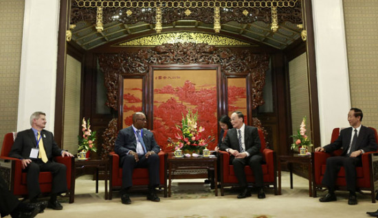 Wang Qishan, head of the Central Commission for Discipline Inspection of the CPC Central Committee, meets Ron Kirk (second left), former US trade representative, and R. James Nicholson (left), former US secretary of veterans affairs, in Beijing on Thursday. (Feng Yongbin/China Daily)