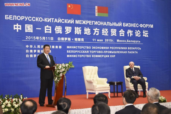 Chinese President Xi Jinping (L) addresses the opening ceremony of a China-Belarus economic and trade forum between local governments of the two countries in Minsk, capital of Belarus, May 11, 2015. Belarusian President Alexander Lukashenko also attended the opening ceremony. Xi arrived here Sunday for a three-day state visit to Belarus, the first by a Chinese head of state in 14 years. (Xinhua/Xie Huanchi)