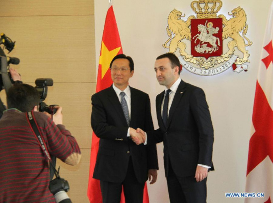 Georgian Prime Minister Irakli Garibashvili (1st R) shakes hands with visiting Chinese Agriculture Minister Han Changfu during their meeting in Tbilist, Georgia, May 11, 2015. (Xinhua/Li Ming)