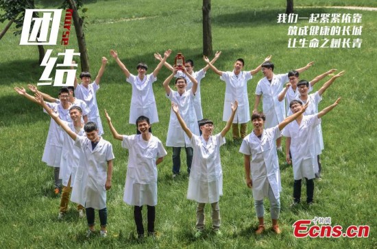 Would-be male nurses studying at the medical school of Jinhua Polytechnic, located in East Chinas Zhejiang province, pose for photos to mark International Nurses Day on May 12, 2015. The students, who are completing a nursing program, say they are proud to work in the female-dominated profession. Official data released by the health authority showed there were 45,000 registered male nurses in 2012, an increase from 39,000 in 2009. (Photo: China News Service/Lu Huiping)