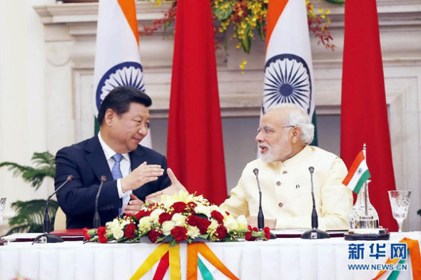 President Xi Jinping and Indian Prime Minister Narendra Modi shake hands at a press conference in New Delhi, India, Sept 18, 2014. (Photo/Xinhua)
