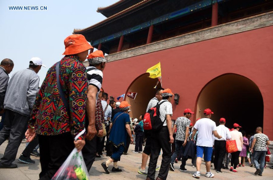 People visit the Palace Museum, also known as the Forbidden City, in Beijing, capital of China, May 17, 2015. The Forbidden City will restrict the number of visitors to no more than 80,000 everyday starting from June 13 this year, or the 10th China Cultural Heritage Day, as a trial to reduce its serving pressure. (Xinhua/Jin Liangkuai)