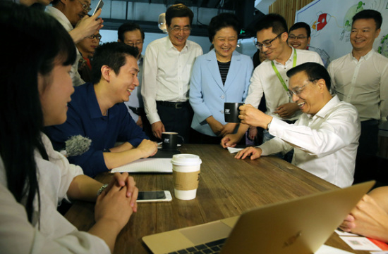 Premier Li Keqiang shares a light moment with entrepreneurs at a 3W Cafe in Zhongguancun Science Park in Beijing on May 7. His visit to Zhongguancun seen as a gesture of government's support for startup businesses [Photo/China Daily]