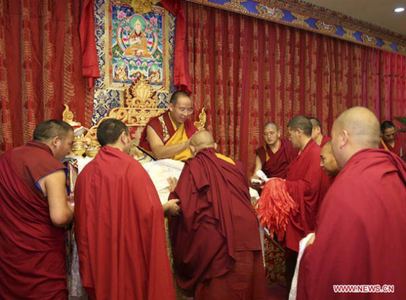 The 11th Panchen Lama Bainqen Erdini Qoigyijabu conducts a ritual to bless Tibetan Buddhism scholars, all monks graduating from the High-level Tibetan Buddhism College of China, in Beijing, captial of China, May 20, 2015. (Photo: Xinhua/Ma Zhancheng) 