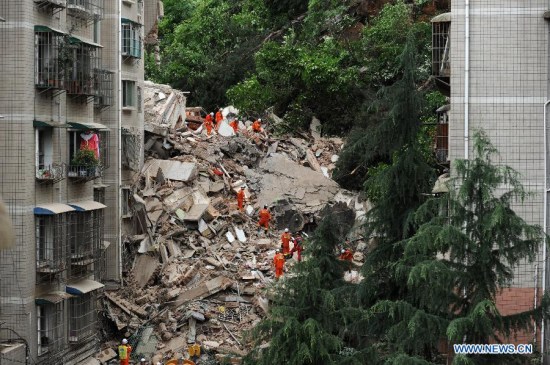 Rescuers search for survivors at a residential building collapse site in Guiyang, capital of southwest China's Guizhou Province, May 20, 2015. A nine-storey building collapsed in Guiyang on Wednesday. Rescuers have confirmed that there are people trapped inside, but casualties are not known yet. (Xinhua/Tao Liang)