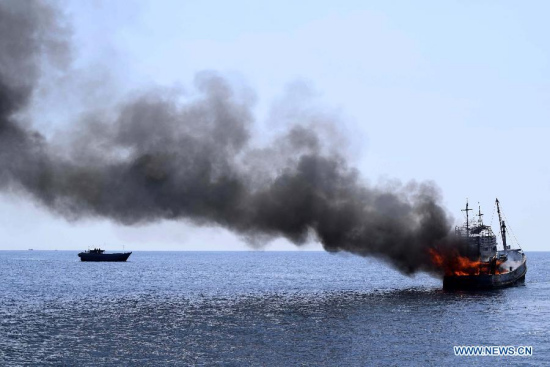 An empty fishing vessel is blown up in the water of East Aceh, Indonesia, May 20, 2015. Media reported 41 empty fishing boats suspected of illegal fishing, including a large Chinese ship seized in 2009, were blown up by Indonesia on Wednesday. Chinese Foreign Ministry voiced serious concern on Thursday over media reports on Indonesia's blowing up of a Chinese fishing boat, urging Indonesia to make clarification. (Xinhua/Hatazmura)