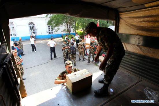 Nepal Army personnel load relief materials to a truck after a handover ceremony of China-aided medical supplies to Nepal in Kathmandu, Nepal, May 27, 2015. Chinese medical aid, including medical equipment, laboratory materials and other medical supplies, is worth 40 million Nepalese rupees (about 390,000 U.S. dollars). (Xinhua/Sunil Sharma)