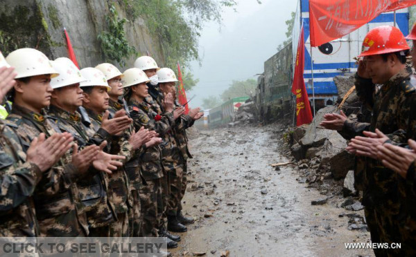 Rescuers celebrate after they cleared a blocked highway linking Tibet and Nepal in southwest China's Tibet Autonomous Region, May 1, 2015. The Chinese side of a key highway linking Tibet and Nepal was cleared of obstructions on Friday morning, six days after an 8.1-magnitude earthquake in Nepal caused landslides that blocked the major trade and tourist route. (Xinhua/Chogo)