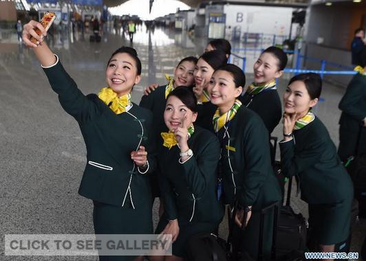 Flight attendants from southeast China's Taiwan pose for a group photo at the Pudong International Airport in Shanghai, east China, May 7, 2015. Twenty-four flight attendants from Taiwan have joined Shanghai's budget carrier Spring Airlines and will serve on flights starting on Thursday. (Photo/Xinhua)