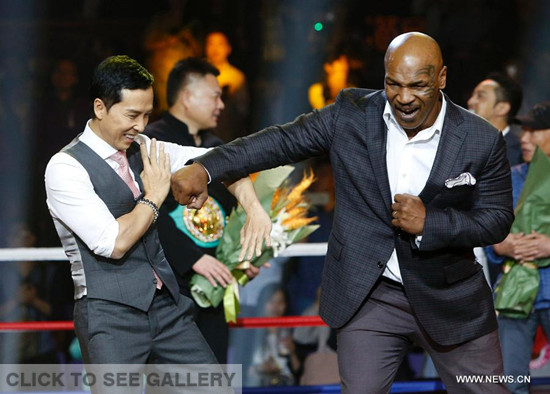 Former heavy weight world champion Mike Tyson (R) and actor Donnie Yen interact with each other during a press conference of the film "Ip Man 3" in Shanghai, east China, May 6, 2015. Mike Tyson is expected to play a role in the film. (Photo: Xinhua/Ding Ting)