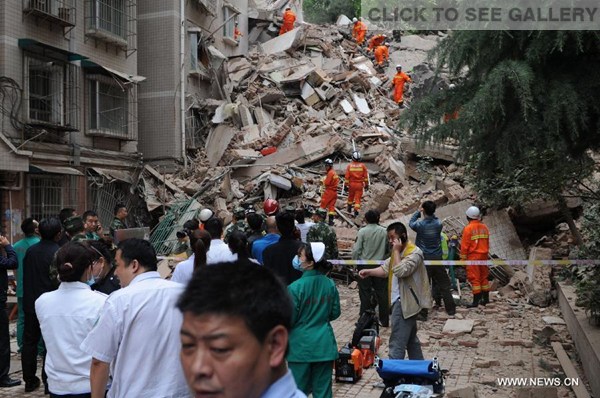 Rescuers search for survivors at a residential building collapse site in Guiyang, capital of southwest China's Guizhou Province, May 20, 2015. A nine-storey building collapsed in Guiyang on Wednesday. Rescuers have confirmed that there are people trapped inside, but casualties are not known yet. (Photo: Xinhua/Long Rui)