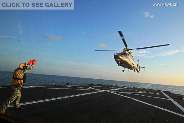 A Dolphin Z-9 helicopter of China's Navy missile frigate CNS Yulin flies off the deck of Singapore's Navy missile frigate RSS Intrepid during the "Exercise Maritime Cooperation 2015", May 25, 2015. (Xinhua/Then Chih Wey) 