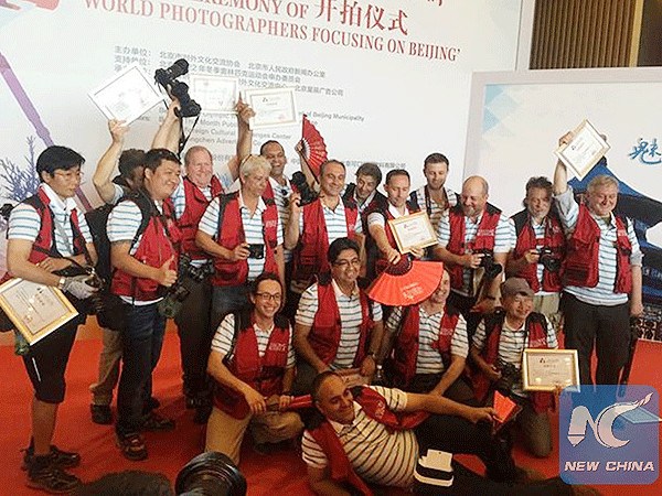 Photographers pose for a group picture before they start a week-long tour around Beijing on May 19, 2015. (Photo/Beijing Bid Committee)