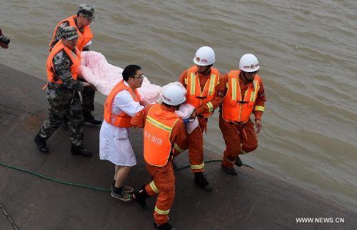 A survivor is saved from the overturned passenger ship in the Jianli section of the Yangtze River in central China's Hubei Province June 2, 2015. (Xinhua/Xiao Yijiu) 