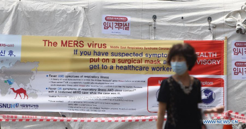 A woman walks past a quarantine tent for people who may be infected with the virus causing MERS at Seoul National University Hospital in Seoul, South Korea, on June 2, 2015. Fears for the Middle East Respiratory Syndrome (MERS) reached a peak in South Korea as the first two deaths and tertiary infection were reported Tuesday. (Xinhua/Yao Qilin)