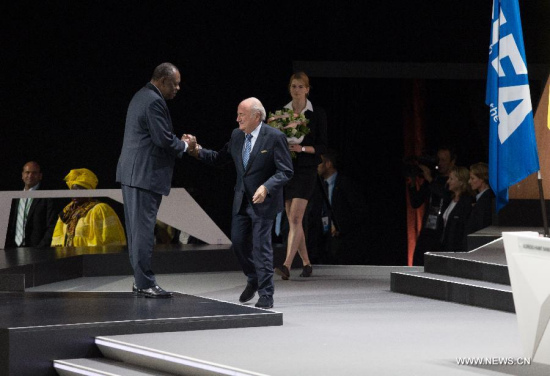 FIFA President Sepp Blatter (R) receives congratulations after being re-elected during the 65th FIFA Congress in Zurich, Switzerland, May 29, 2015. (Photo: Xinhua/Xu Jinquan)